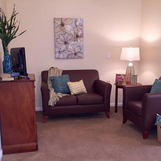 Cozy living room with comfortable seating and warm lighting.