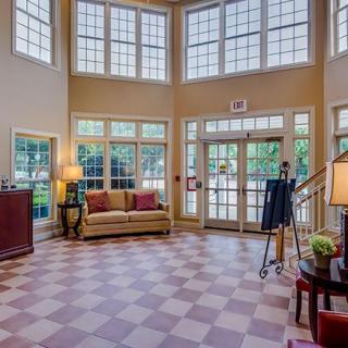 Spacious lobby area with large windows and elegant decor.