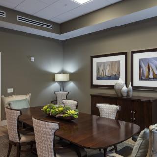 A modern dining room with elegant furniture and tasteful decorations.