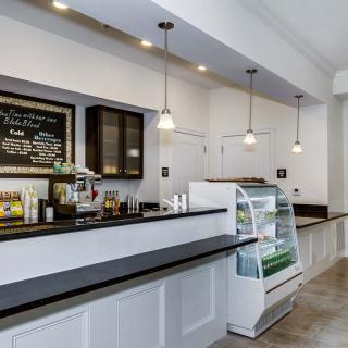 A modern cafe interior with a clean counter and display case.