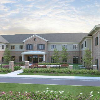 A modern two-story residential building with landscaped surroundings.