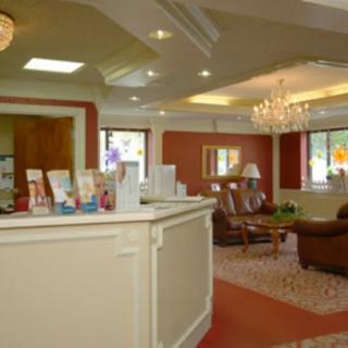 A well-decorated lobby with comfortable seating and a chandelier.
