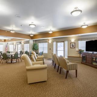 A spacious living room with comfortable seating and a large television.