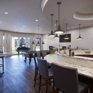 Modern home bar area featuring a pool table, piano, and stylish lighting design.