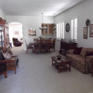 A spacious living and dining area featuring comfortable seating and elegant decor.