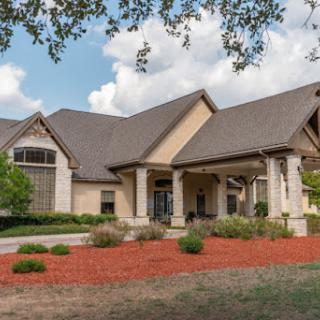 A beautifully designed residential house with a spacious front yard and elegant architecture.