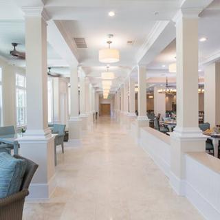 A spacious, modern hallway with elegant lighting and comfortable seating.