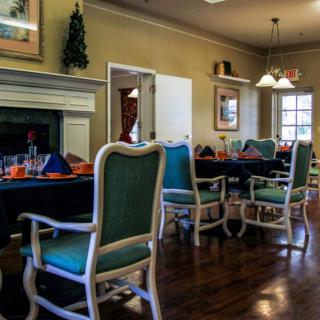 A cozy dining room with elegant furniture and warm lighting.