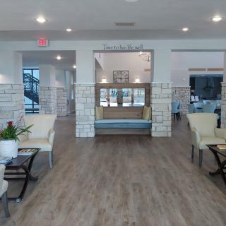 A spacious and modern lobby with comfortable seating areas and decorative plants.