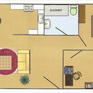 This is a floor plan of an apartment showing the layout of a living room, kitchen, and bathroom with furniture placement.