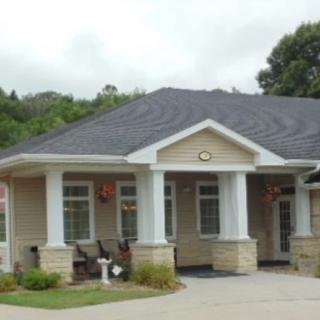 A small single-story house with a front porch and a well-maintained exterior.