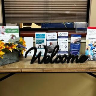A welcoming setup with brochures and floral arrangement in a healthcare waiting area.