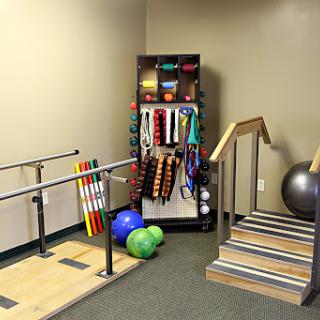 A well-equipped physical therapy room featuring various equipment for rehabilitation and exercise.