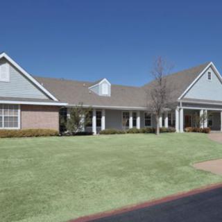 A suburban residential house with a well-maintained lawn.