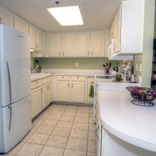 A modern kitchen with white cabinets and a spacious countertop.