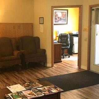 A cozy office waiting area with chairs and a table topped with magazines.