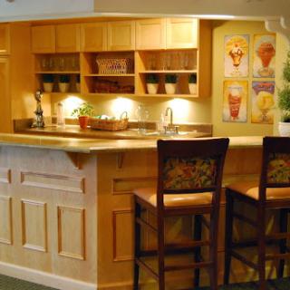 A warm and inviting kitchen bar with wooden cabinetry and soft lighting.