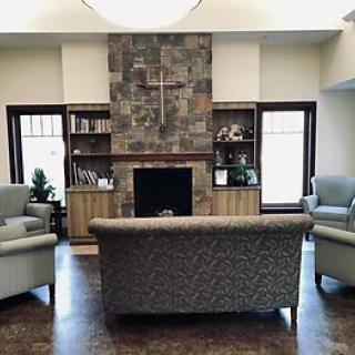 Cozy living room with a stone fireplace and comfortable seating.