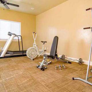 A home gym featuring various exercise equipment including a treadmill and stationary bike.