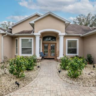 A single-story house with a welcoming front pathway and landscaped yard.