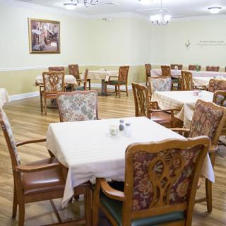 A spacious dining area with neatly arranged tables and chairs.