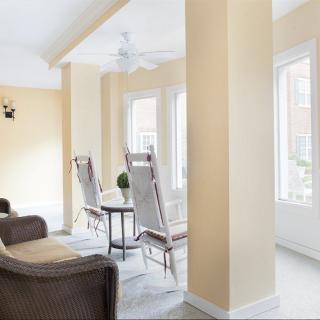 A bright and airy living room with comfortable seating and large windows letting in natural light.