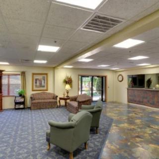 A spacious lobby with comfortable seating and a reception desk.