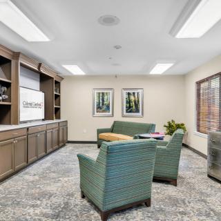 A modern lobby area with comfortable seating and a television.