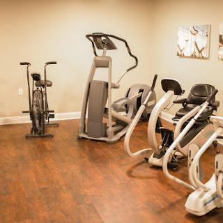 A well-equipped indoor gym area featuring various exercise machines.
