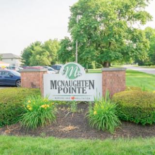Entrance sign for McNaughten Pointe surrounded by well-maintained landscaping.