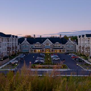 Aerial view of a modern residential building complex during sunset.