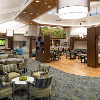 A spacious and modern lounge area featuring comfortable seating and contemporary design elements.