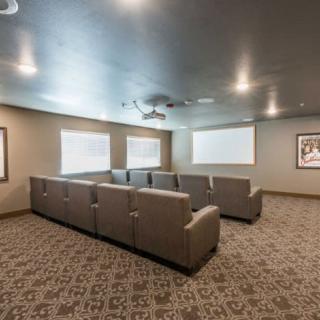 A cozy home theater setup with comfortable seating and a projector screen.