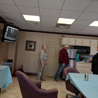 A casual gathering in a kitchen area with people interacting.