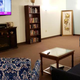 Cozy living room with bookshelf and TV.