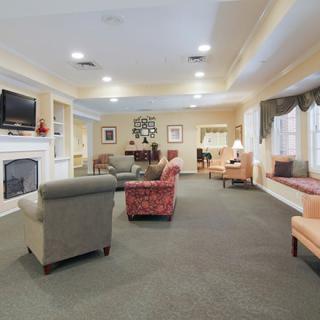 A spacious living room with cozy seating and a fireplace.