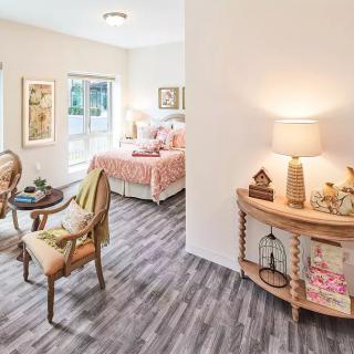A cozy and well-decorated bedroom featuring elegant furniture, warm lighting, and stylish wood flooring.