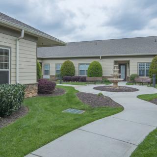 A residential area featuring a well-maintained garden and pathway.