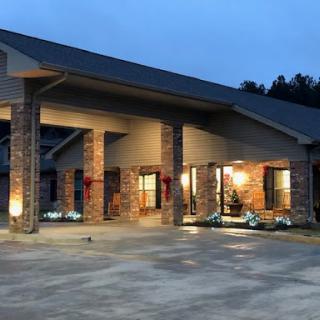 A beautifully lit modern building at dusk, showcasing its architectural design.