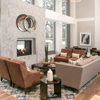A modern living room featuring a fireplace, stylish furniture, and elegant decor.