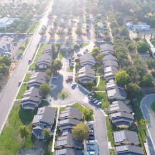 Aerial view of a peaceful suburban neighborhood showcasing rows of houses and well-maintained streets.