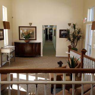 A well-decorated hallway with artwork and plants.