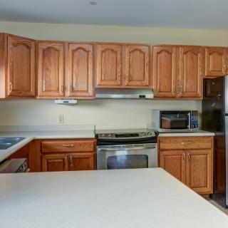 A modern kitchen featuring wooden cabinets and stainless steel appliances.