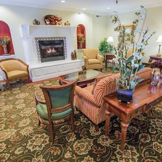 A cozy living room featuring a fireplace and elegant furniture.