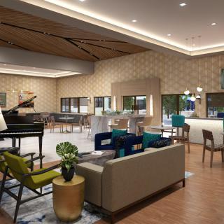 A modern hotel lobby with stylish seating, a grand piano, and a contemporary bar.