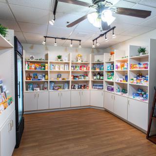 A well-organized pet supply store with shelves stocked full of various products.