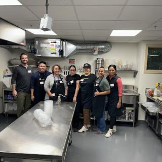 A dedicated team of volunteers gathered in the kitchen, ready to prepare meals together.