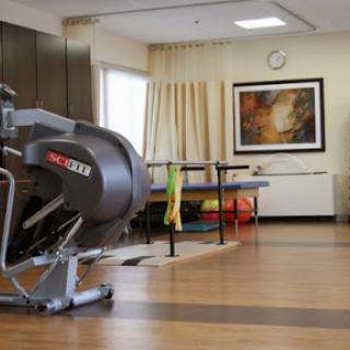 A well-equipped rehabilitation therapy room featuring modern exercise equipment and a calming atmosphere.