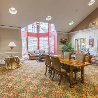 A cozy lobby area with seating and a bright window providing ample natural light.