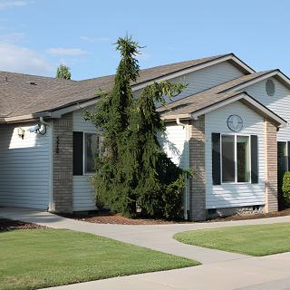 A suburban house with a neatly maintained lawn and well-defined architecture.